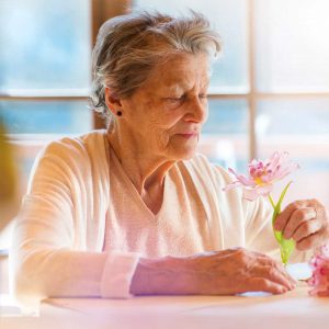 Preffered Cares - Senior Woman Holding A Rose