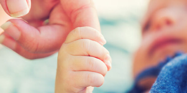 Pediatrics At Home - Infant Holding Caregiver Hand